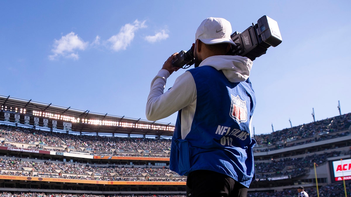 NFL Films cameraman on field