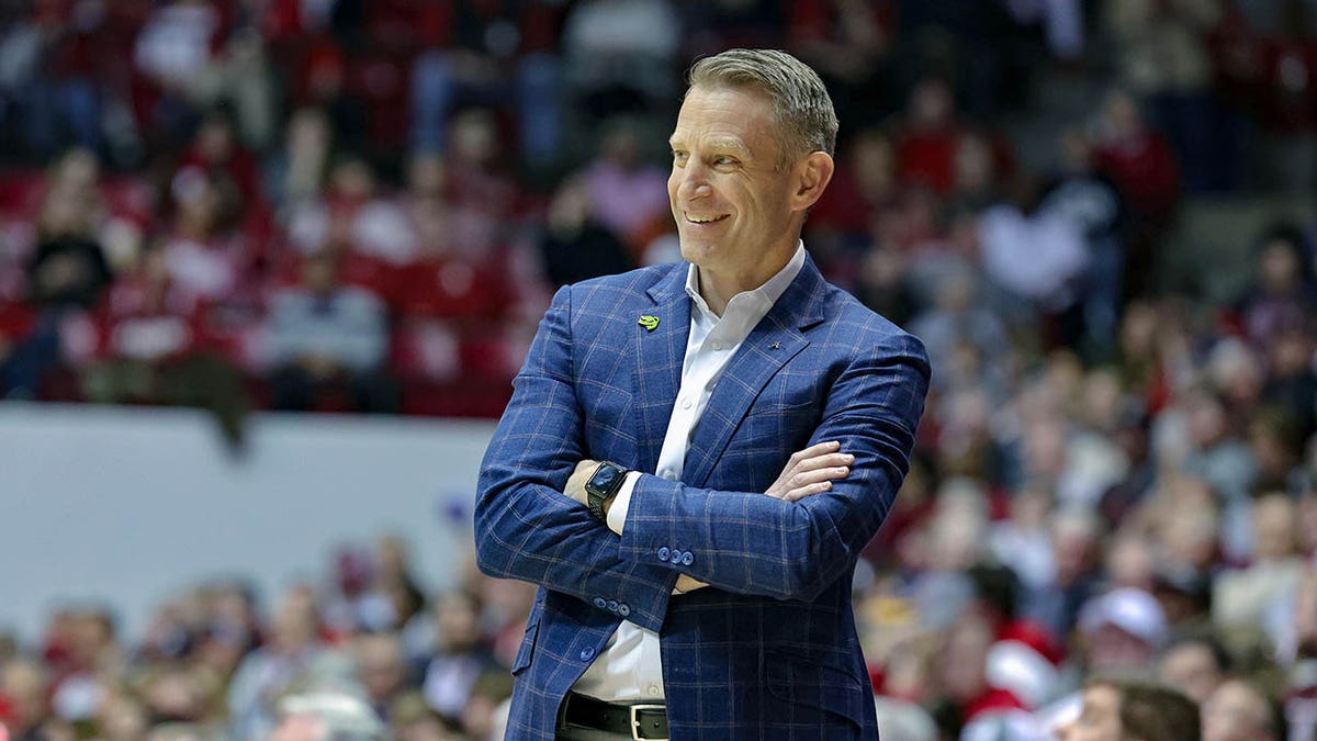 Nate Oats smiles with arms crossed