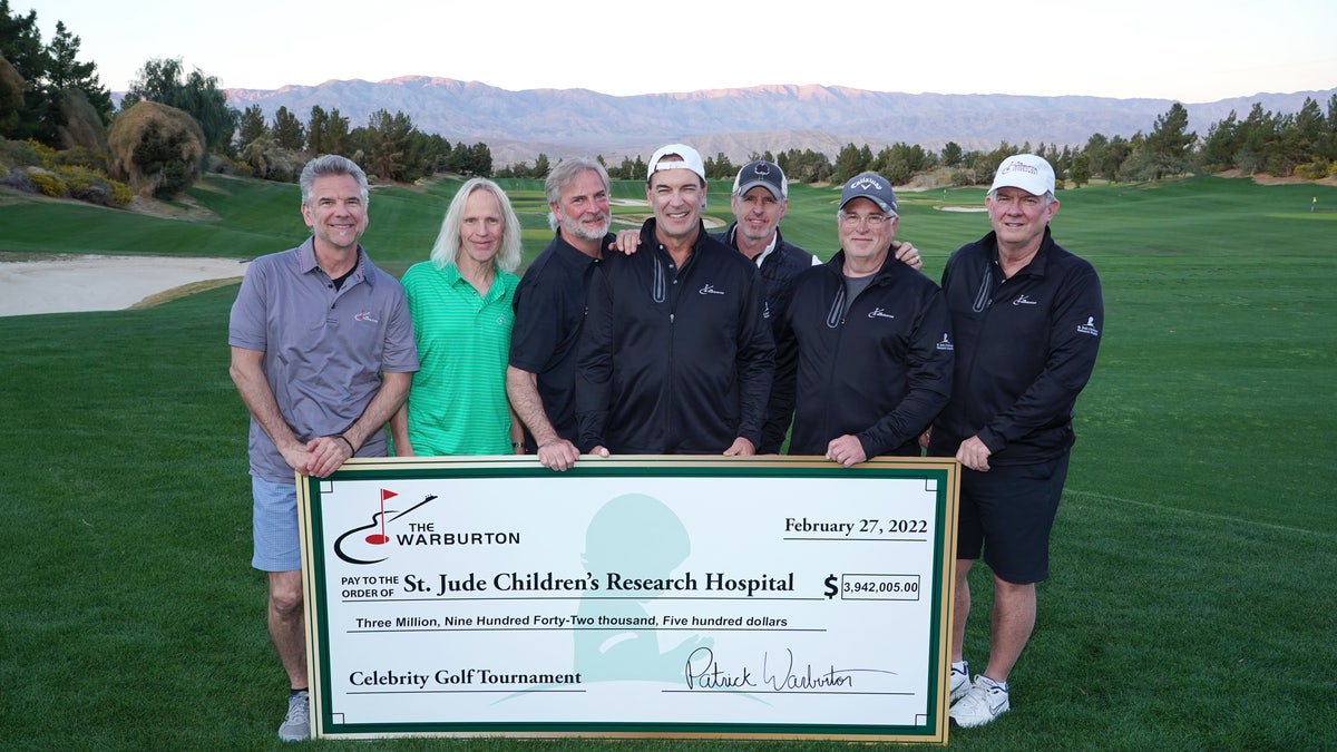 Patrick Warburton holds check on golf course