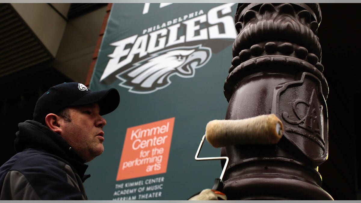 Philadelphia worker greases light pole