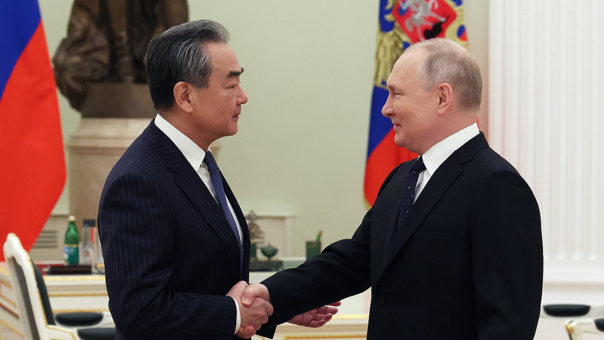 Vladimir Putin meets China's top diplomat in Moscow, Russia