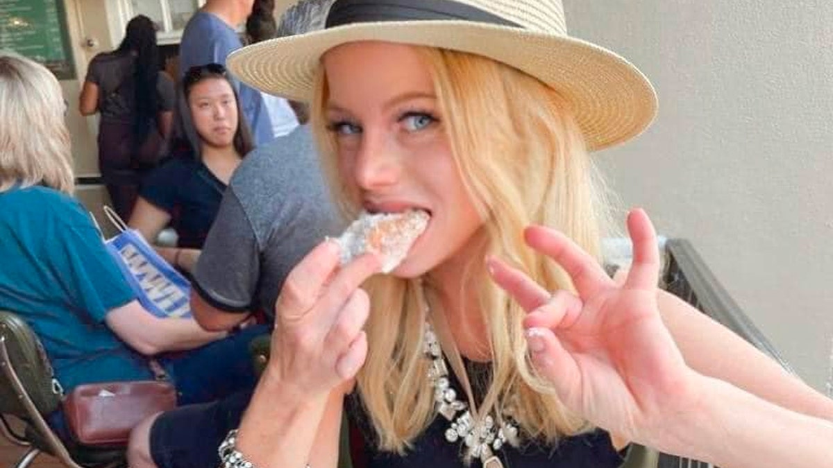 Rachel Schwartz gestures while biting into a pastry