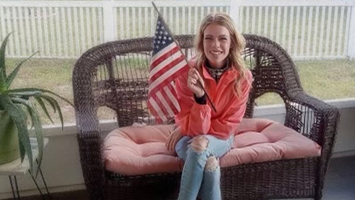 Rachel Schwartz waves an American flag