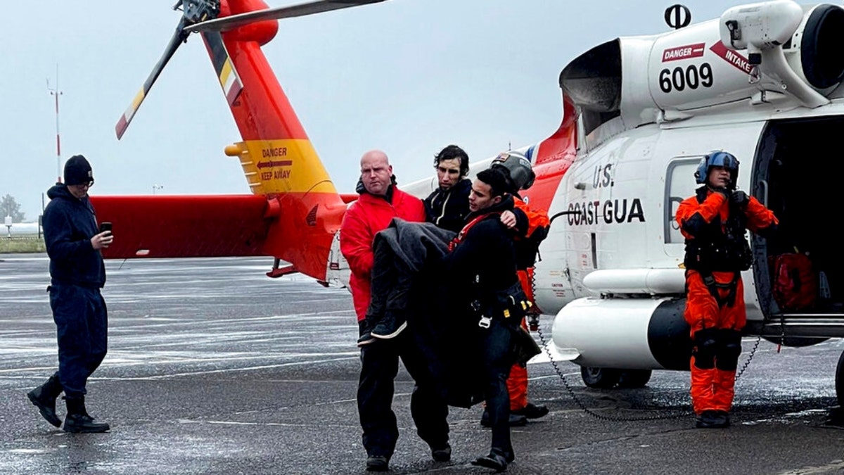 U.S Coast Guard Pacific Northwest, Coast Guard personnel help carry a swimmer