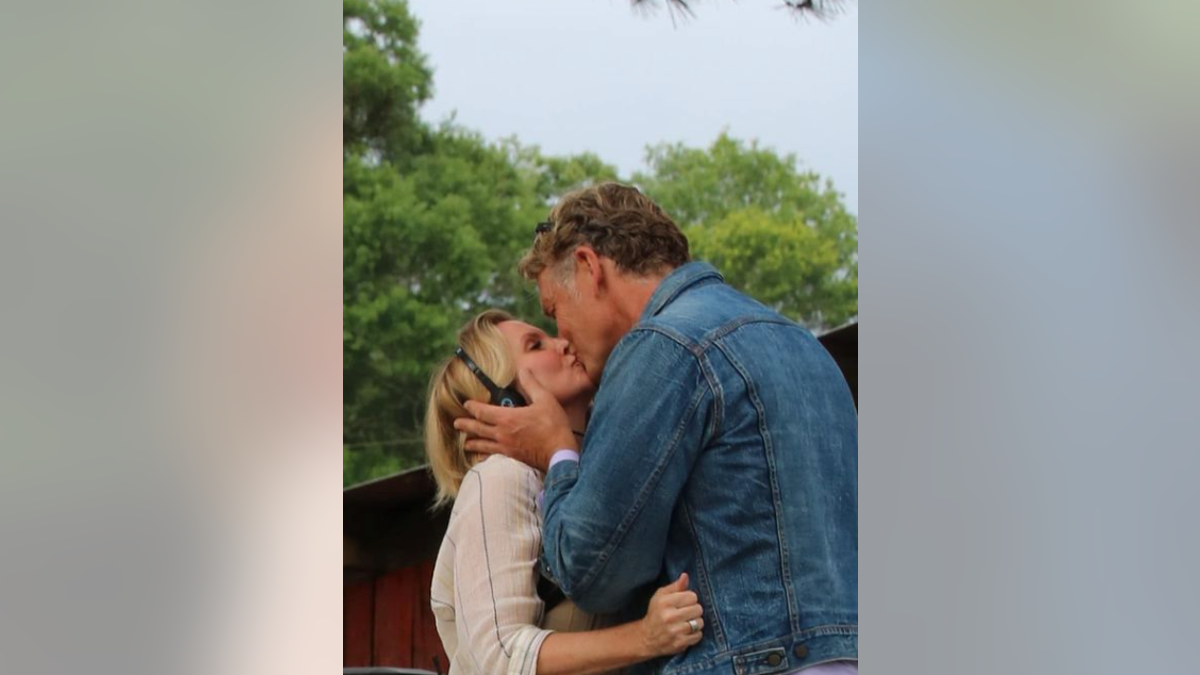 John Schneider Alicia Allain kissing photo