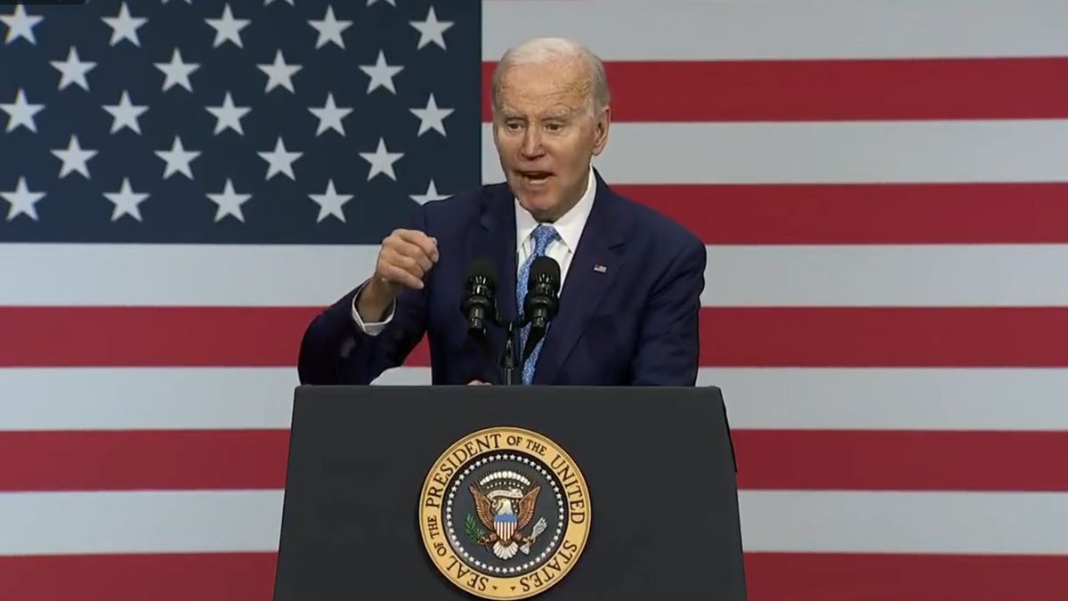 Biden speaking at podium in front of American flag