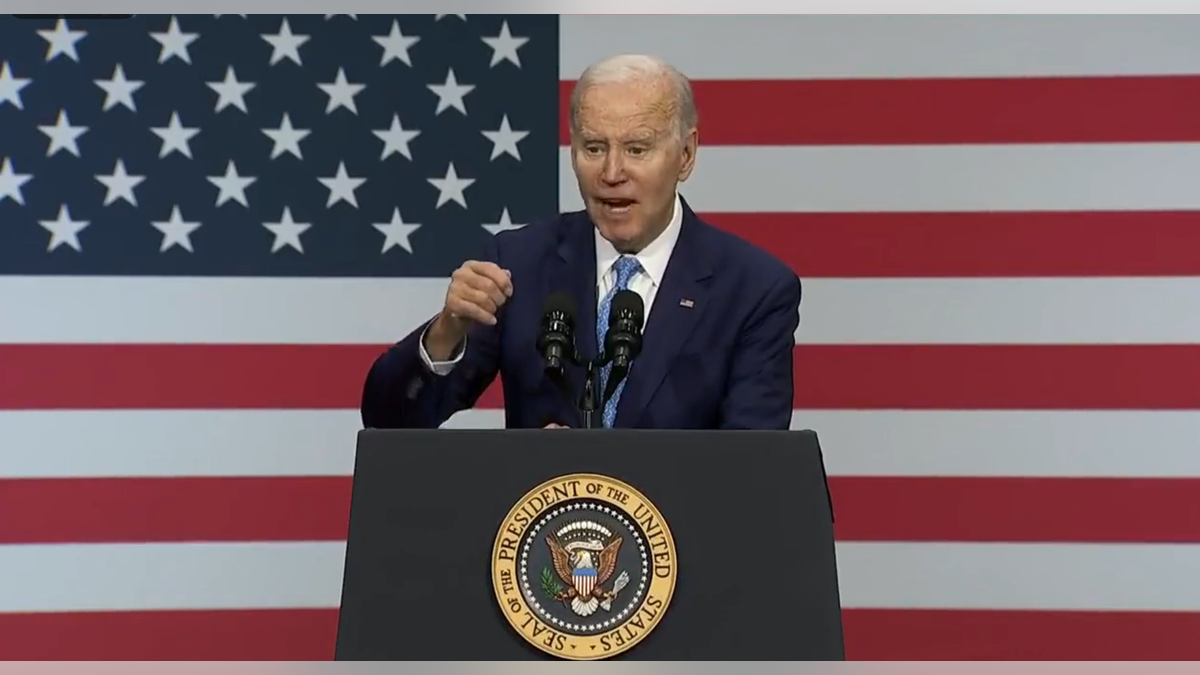 Biden speaking at podium in front of American flag