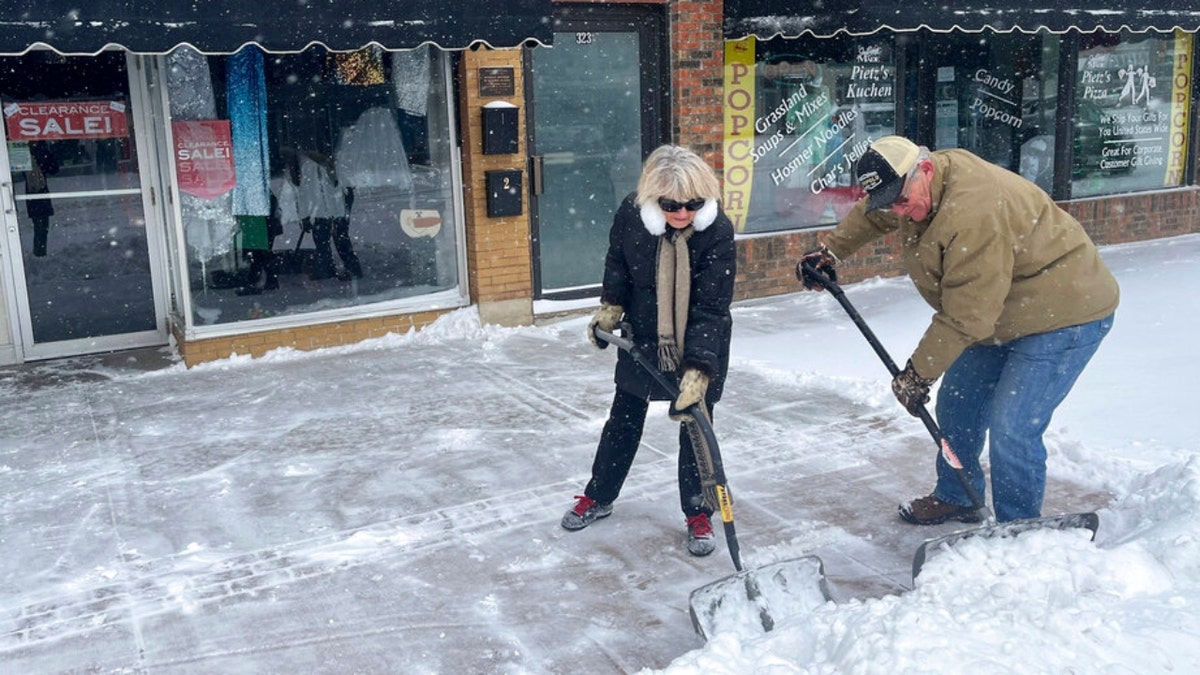 A couple shovels snow in South Dakota