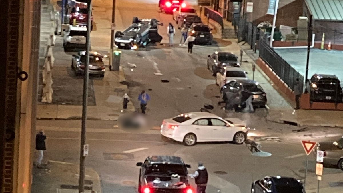 Upturned car as victim treated in the street