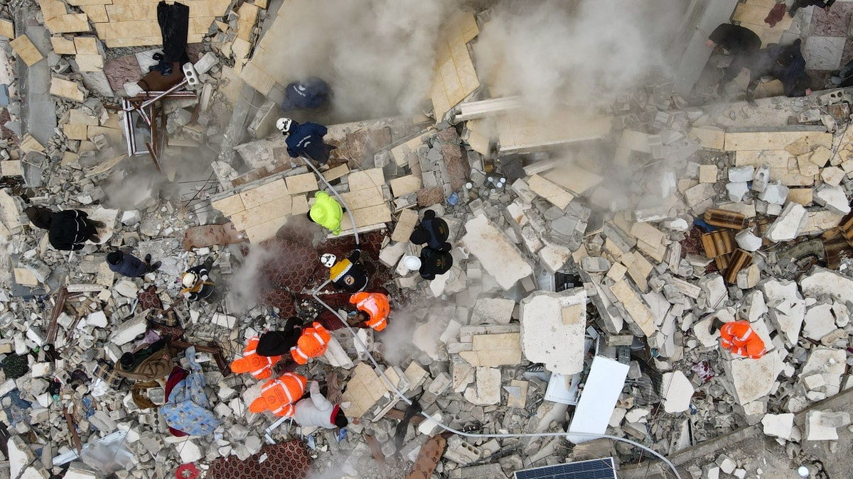 Residents work amid debris in Syria