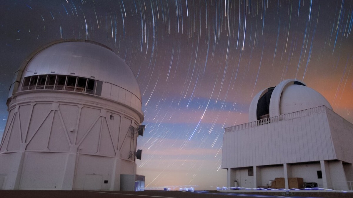 This long-exposure photograph shows the motion of stars during the night above the Blanco 4-meter telescope and the SMARTS 1.5-meter telescope