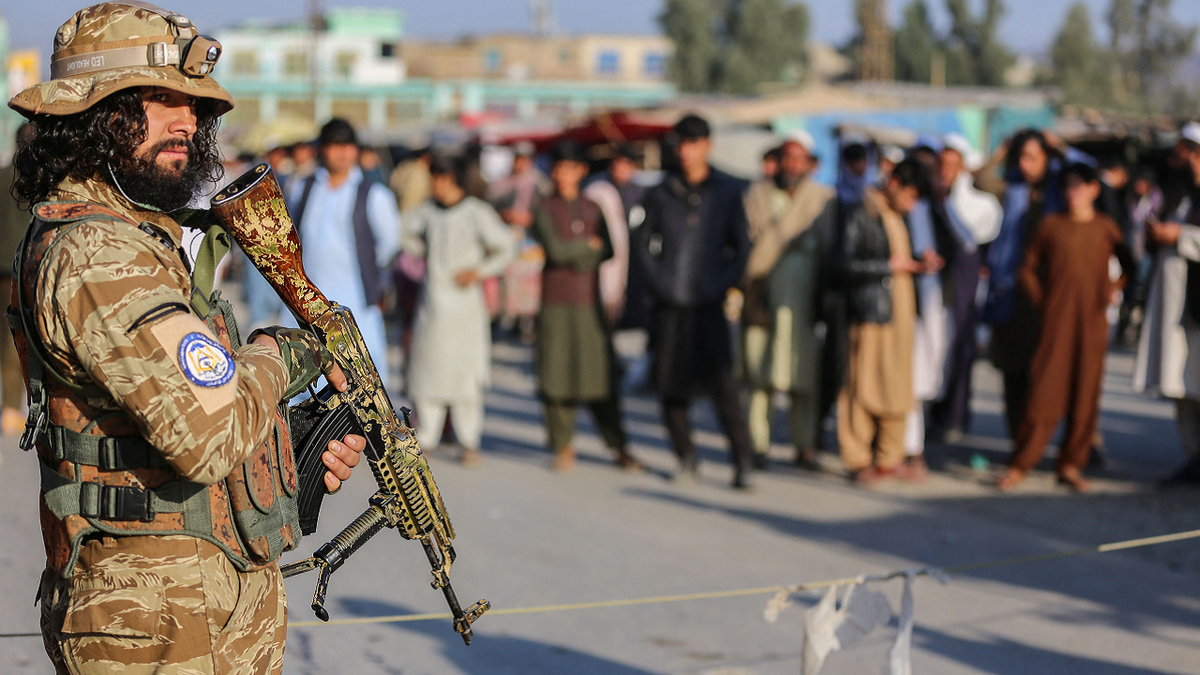 Taliban member stands guard near Afghanistan-Pakistan border crossing