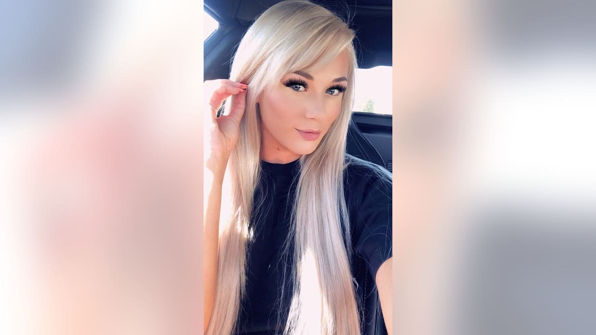 Tiara Tae tugs her hair back in a selfie