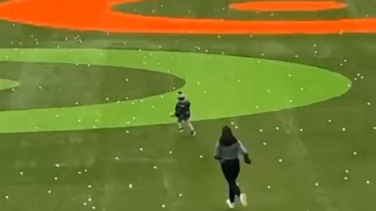 Child runs out onto Topgolf driving range