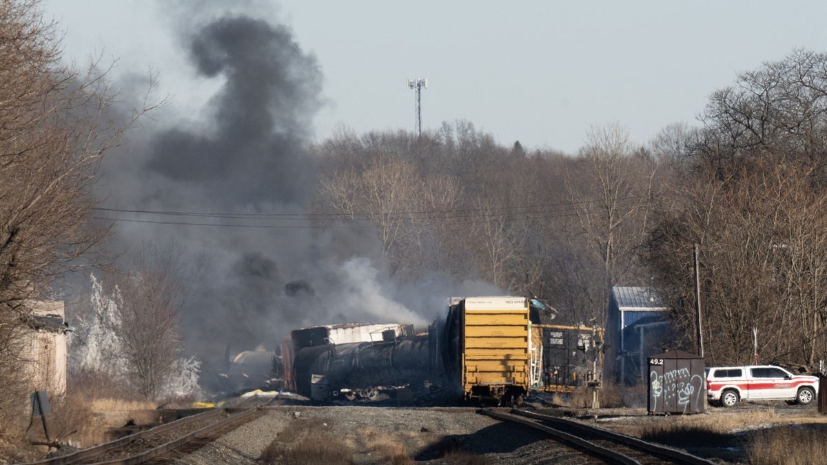 Smoke rises from a derailed cargo train in East Palestine, Ohio