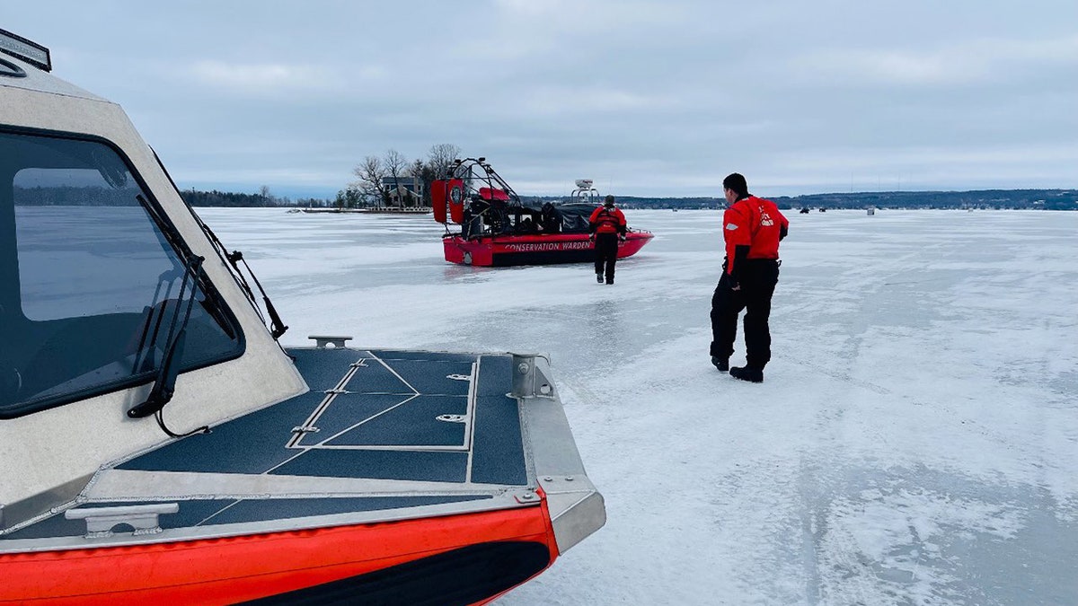 USCG crew on ice with boats