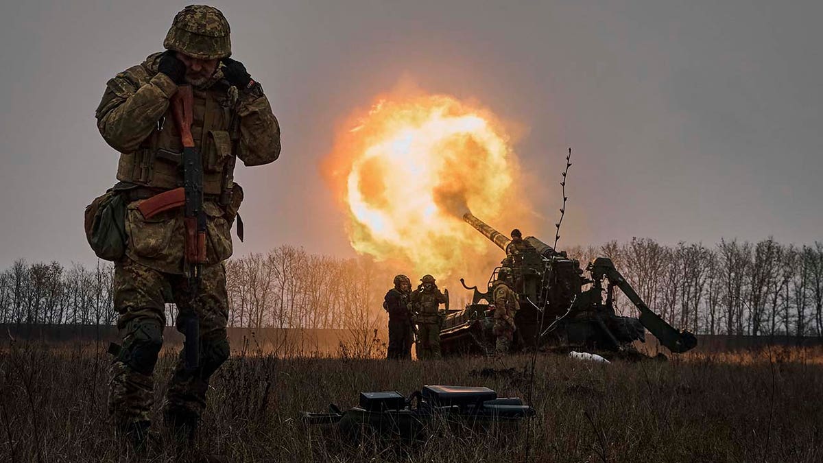 Ukrainian soldiers fire a Pion artillery system at Russian positions near Bakhmut. The U.S. will soon deliver cluster munitions to Ukrainian forces.
