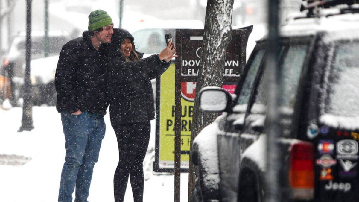 A couple takes a selfie in downtown Flagstaff, Arizona