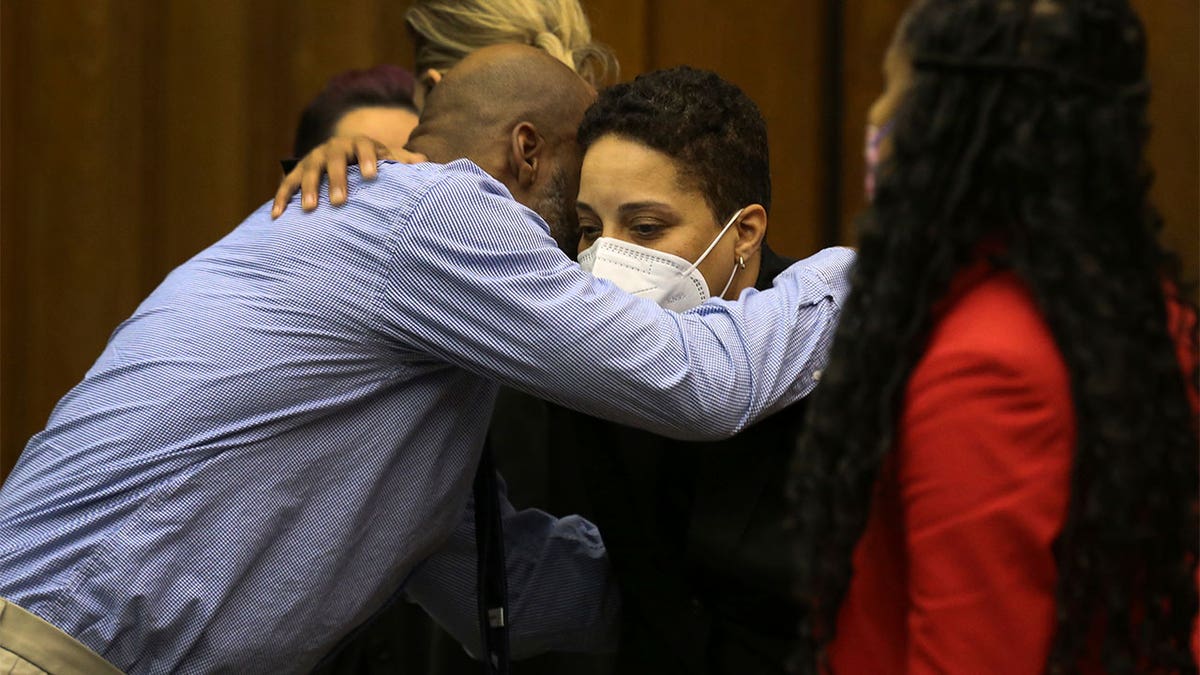 Lamar Johnson wearing a blue shirt hugging the Prosecutor