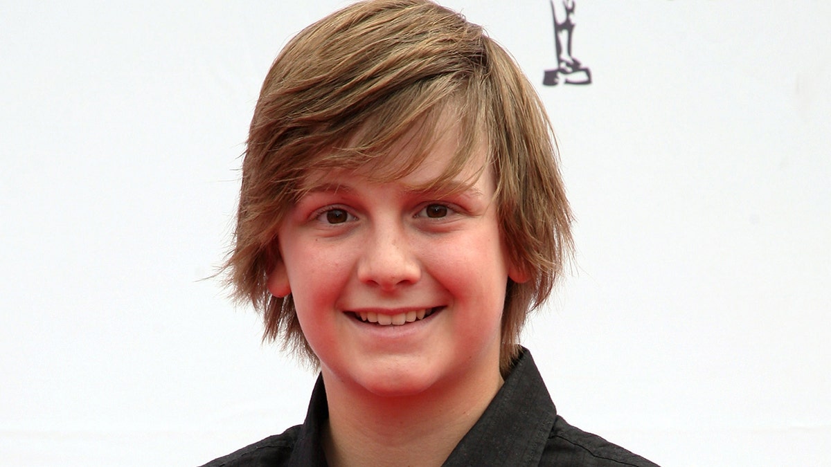 Austin Majors smiling at an event