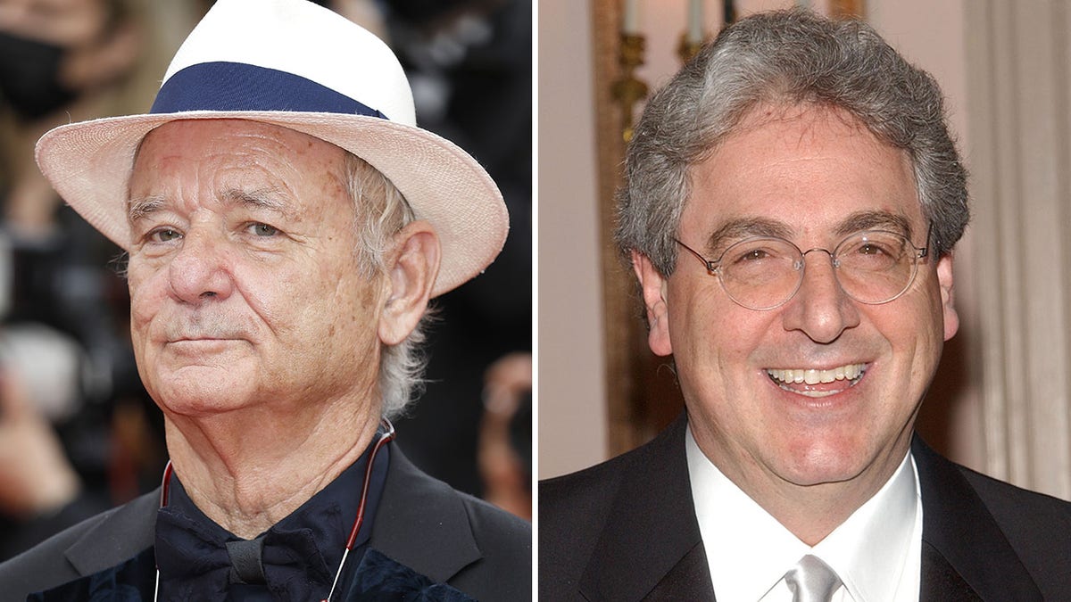 Bill Murray stoic on the red carpet in a black button down shirt and cream hat with a black band split Harold Remis in a white shirt, black suit, and silver tie