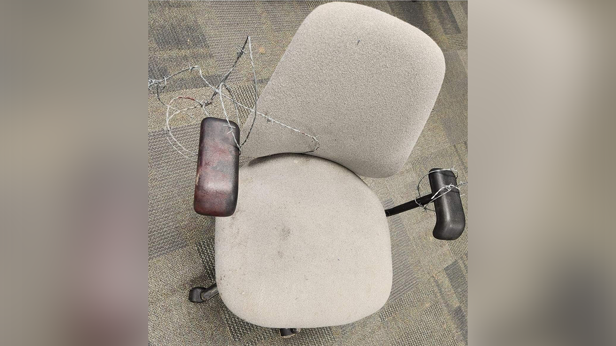 Photo of a chair with barbed wire on it