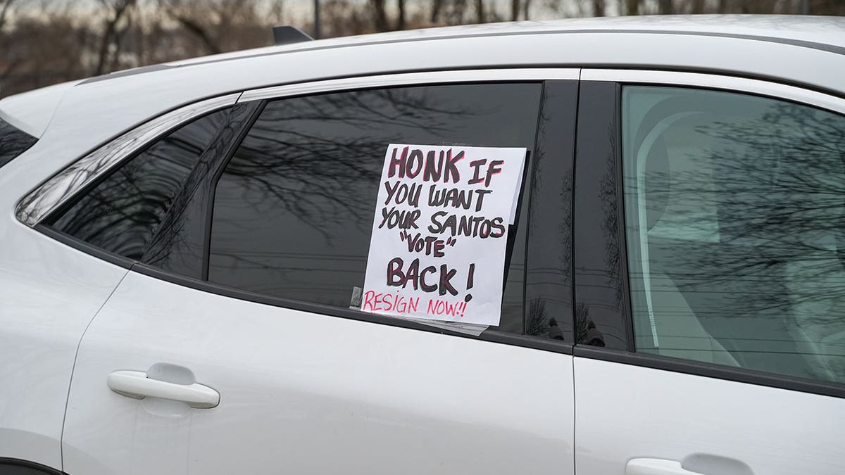 Car has sign taped on window calling for George Santos resignation