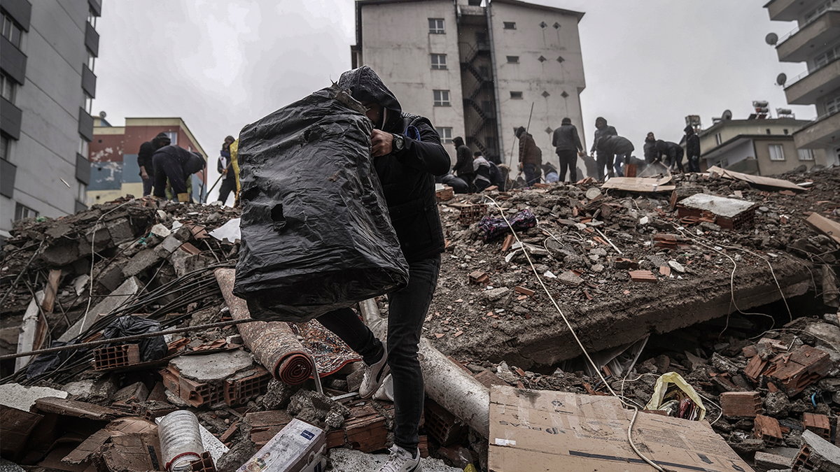 People searching through the rubble after earthquake