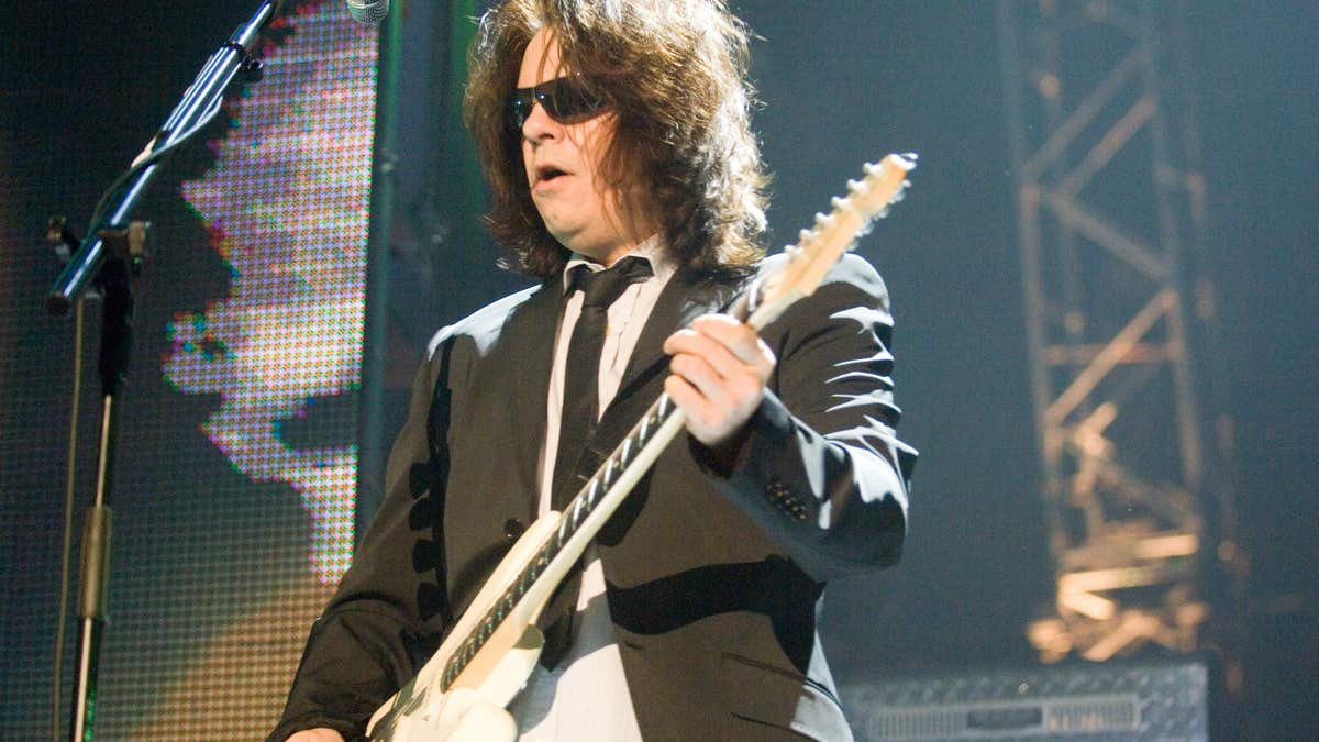 Andy Taylor plays guitar during Duran Duran concert