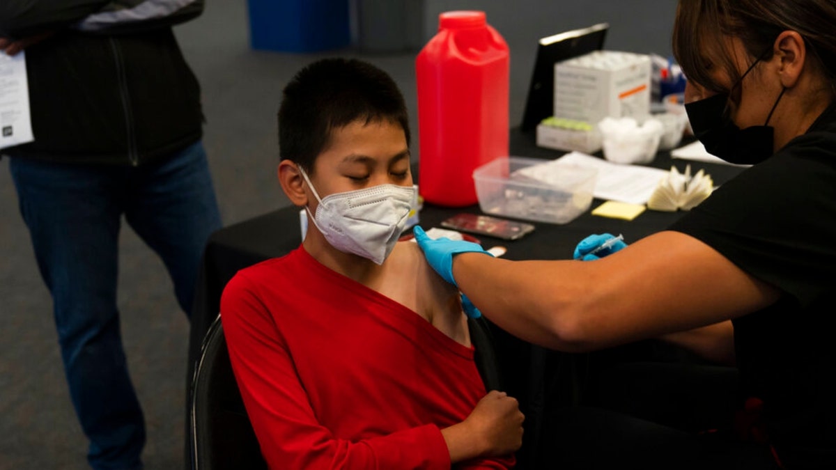 A child receives a pediatric COVID-19 vaccine