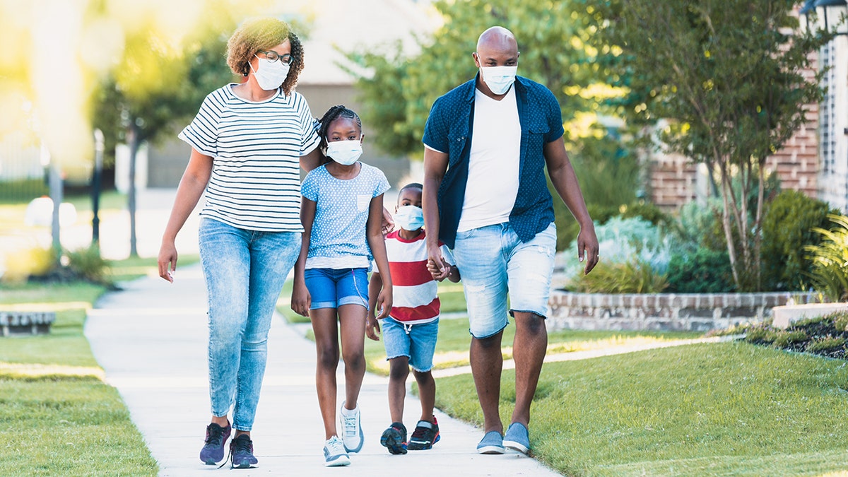 family wearing masks on walk