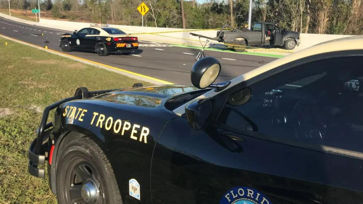 closeup of Florida Highway Patrol vehicle with police tape in the background