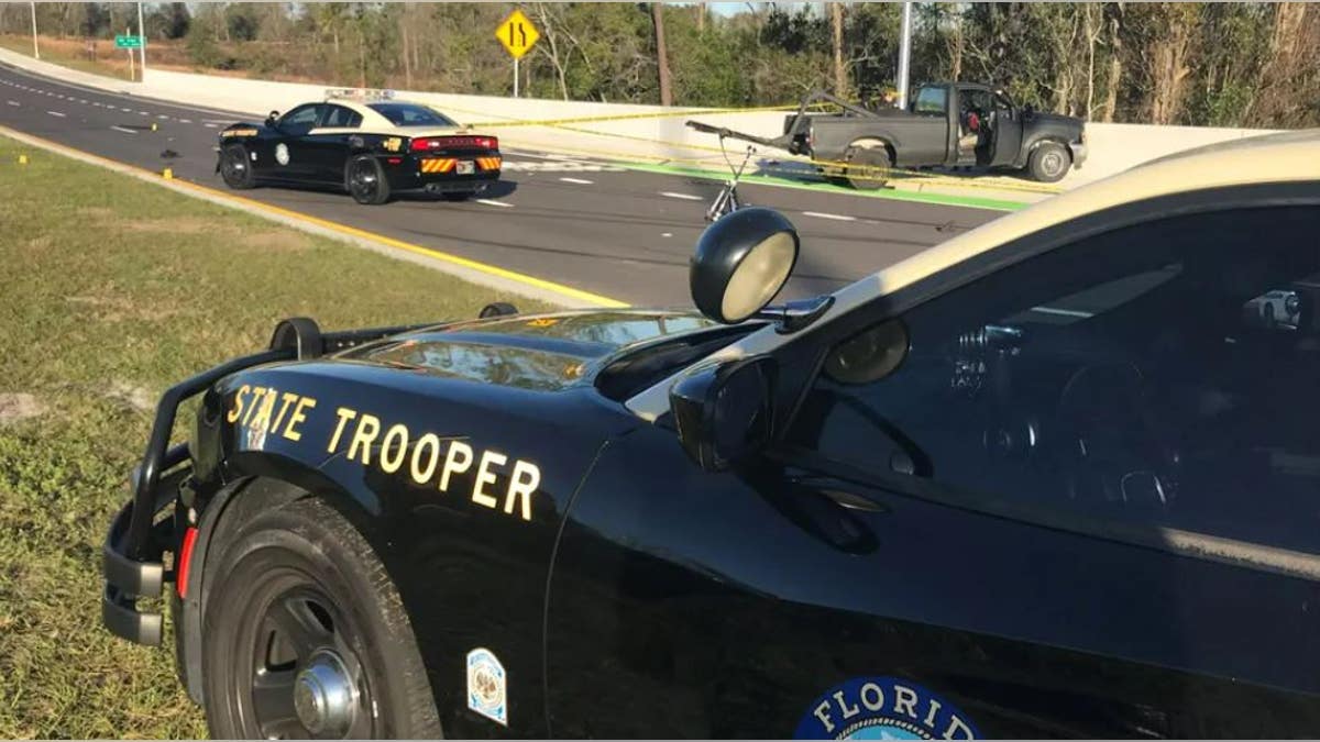 closeup of Florida Highway Patrol vehicle with police tape in the background