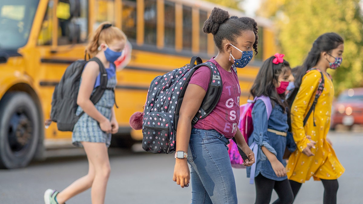 little girls wearing masks