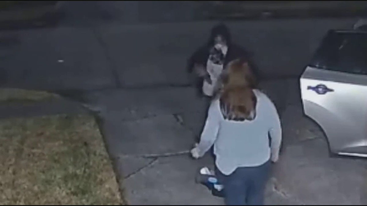 suspect pointing gun at woman