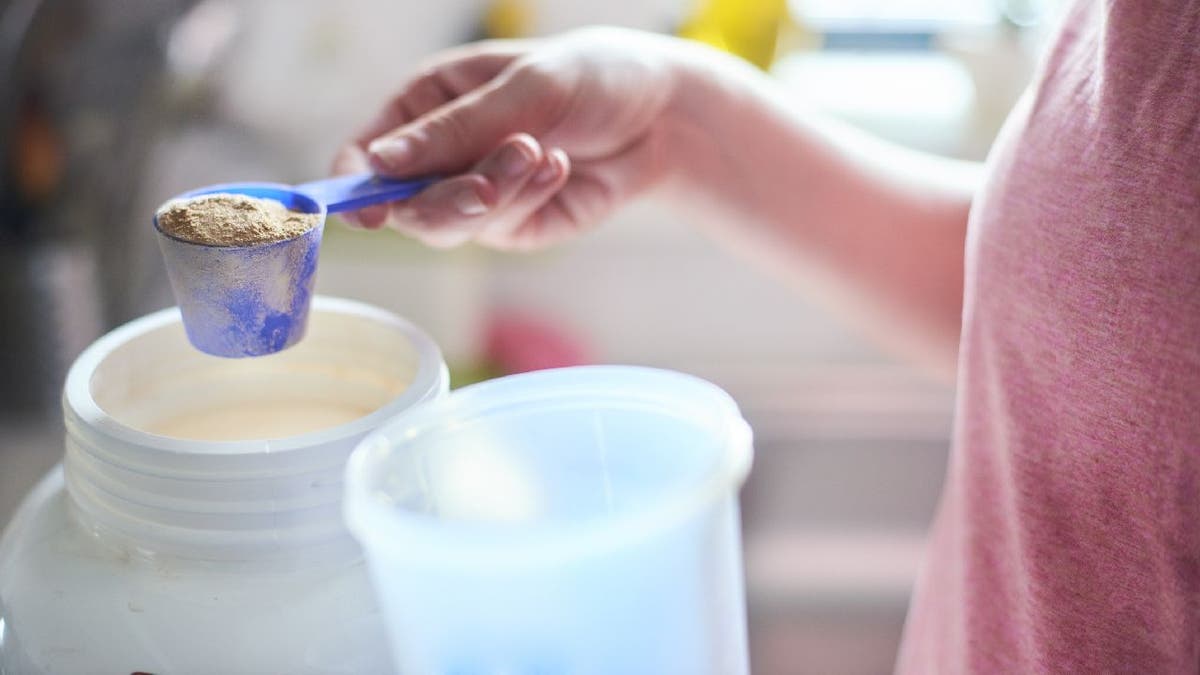 Protein powder gets scooped by hand