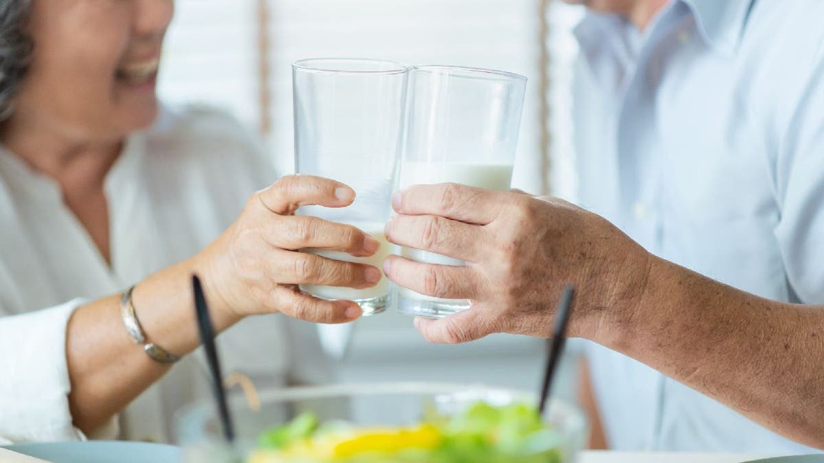 Couple toasts glasses of milk