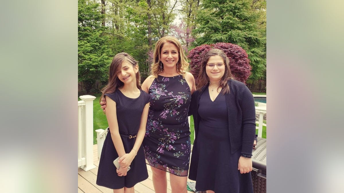 Sheryl Goldstein poses with her two daughters.