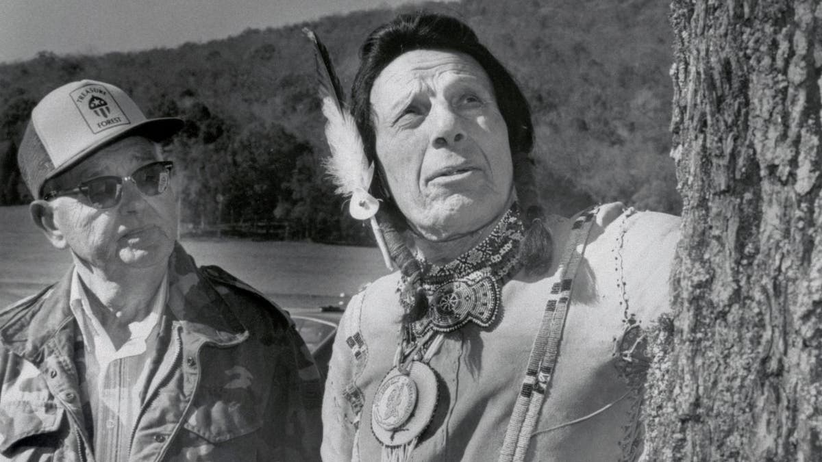 Iron Eyes Cody inspecting tree