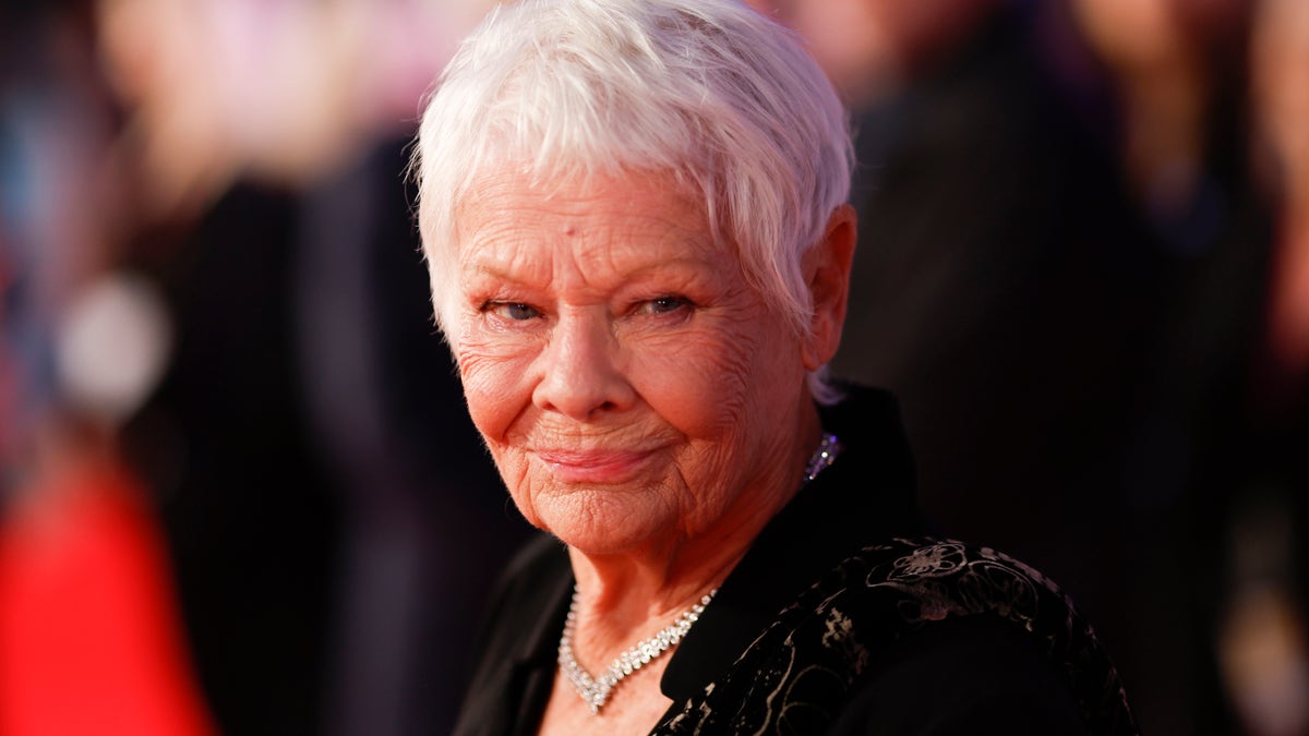 Judi Dench smiles on the red carpet of a film festival