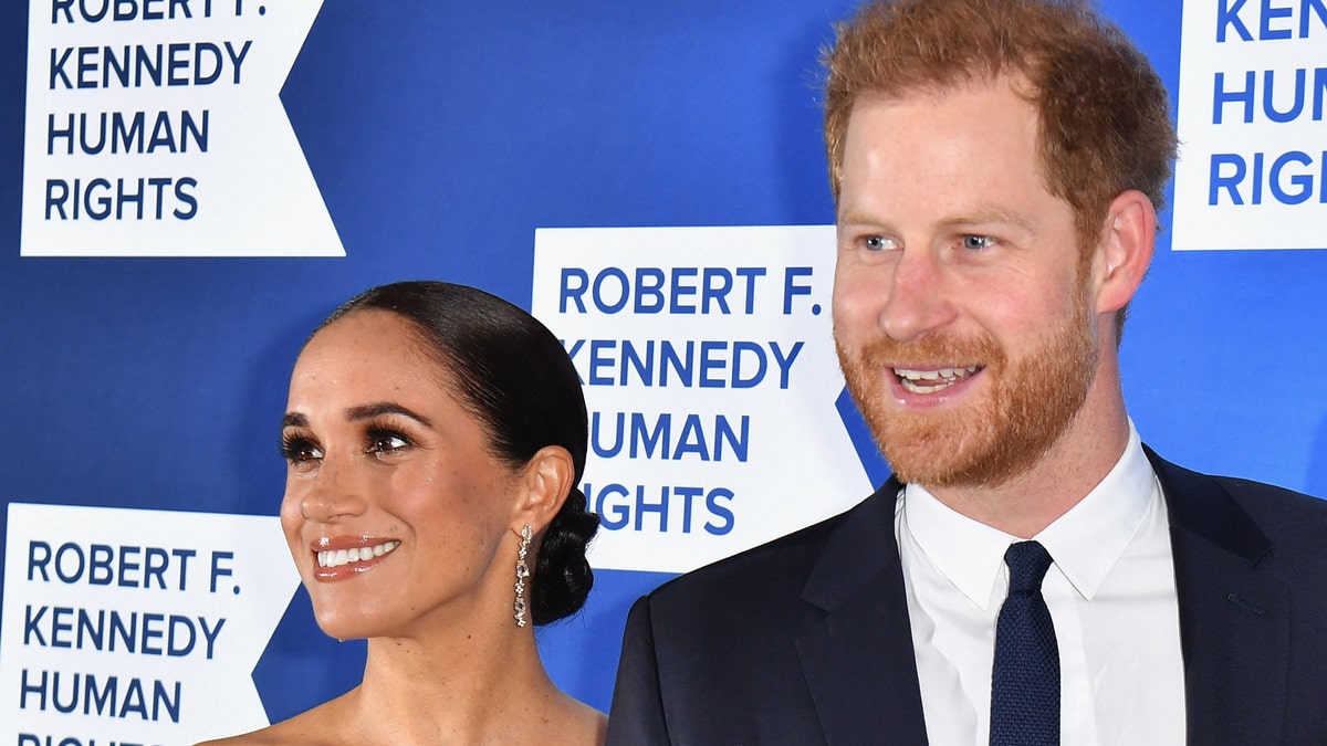 Meghan Markle and Prince Harry smile at a red carpet event