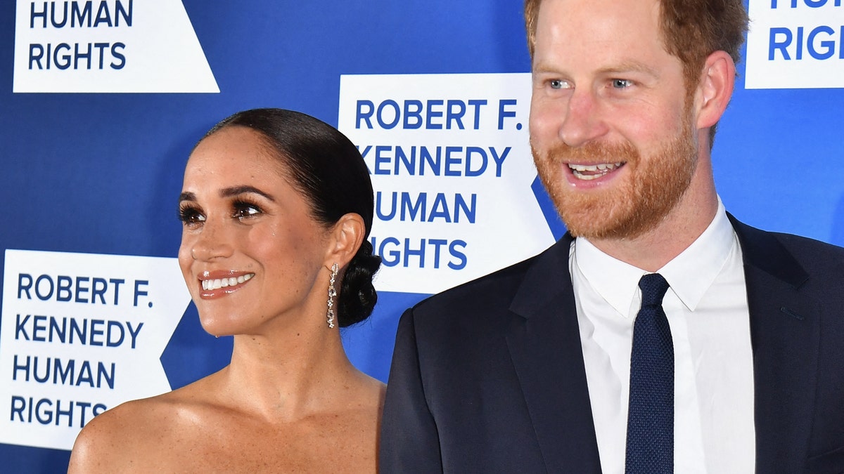 Meghan Markle and Prince Harry smile at a red carpet event