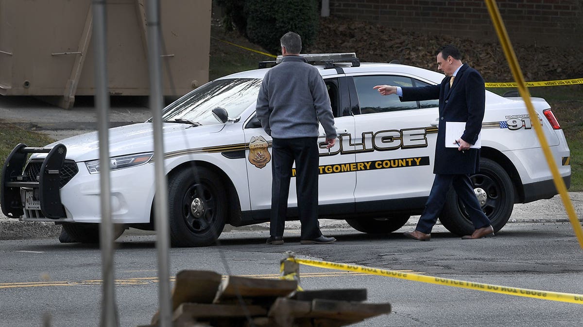 Montgomery County police with patrol car at crime scene