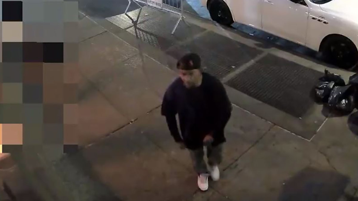 male suspect walking on sidewalk