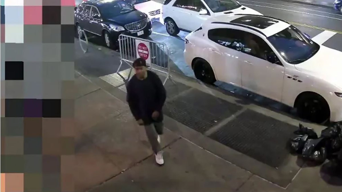 male suspect walking on sidewalk