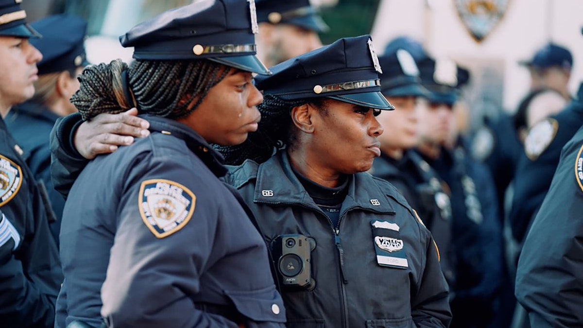 NYPD police office crying outside mosque