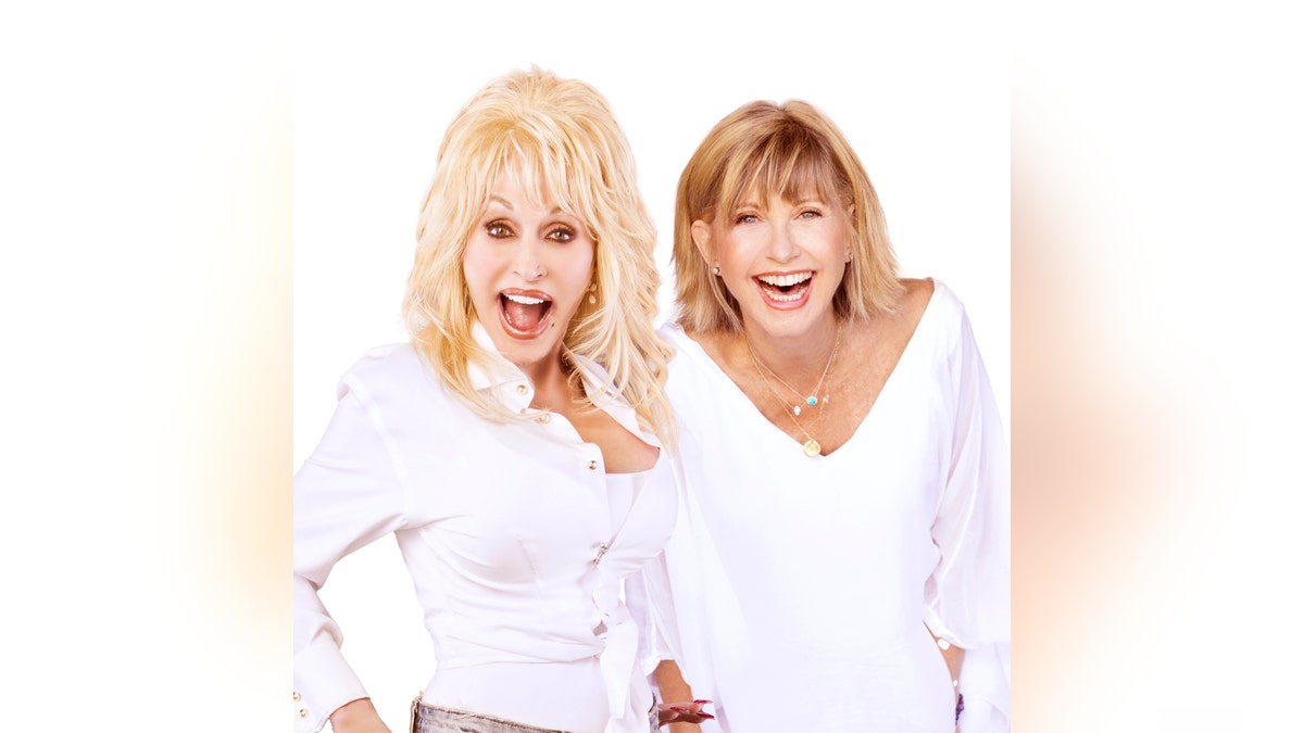 Dolly Parton and Olivia Newton-John smile for a photo together