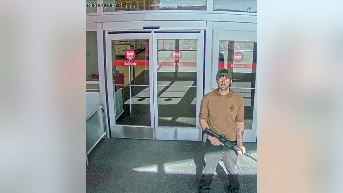 Joseph Jones with rifle at Target entrance