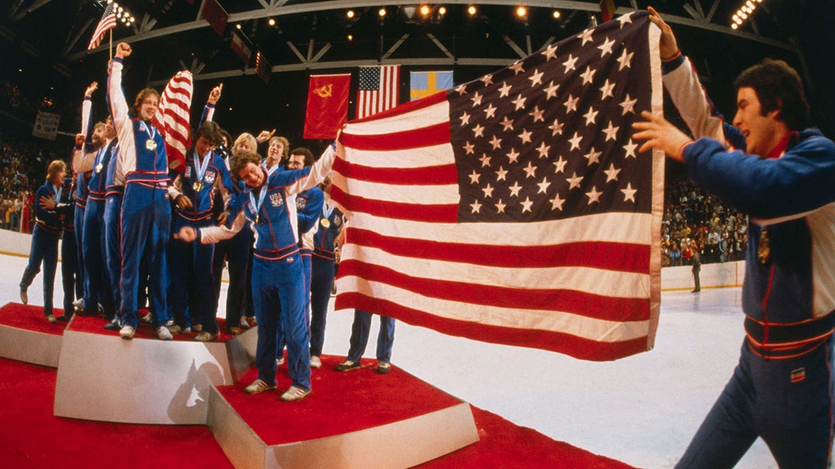 Jim Craig Signed 1980 USA Hockey Miracle on Ice Team on Gold Medal Podium