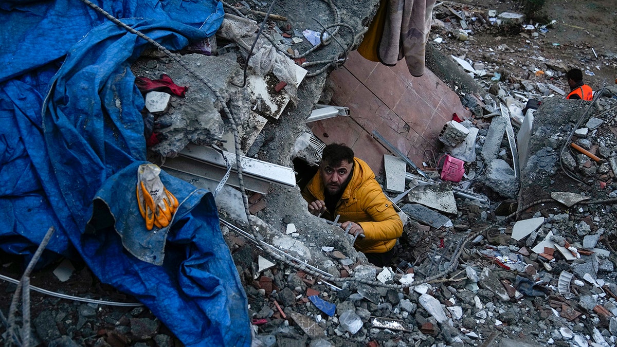 man climbing debris